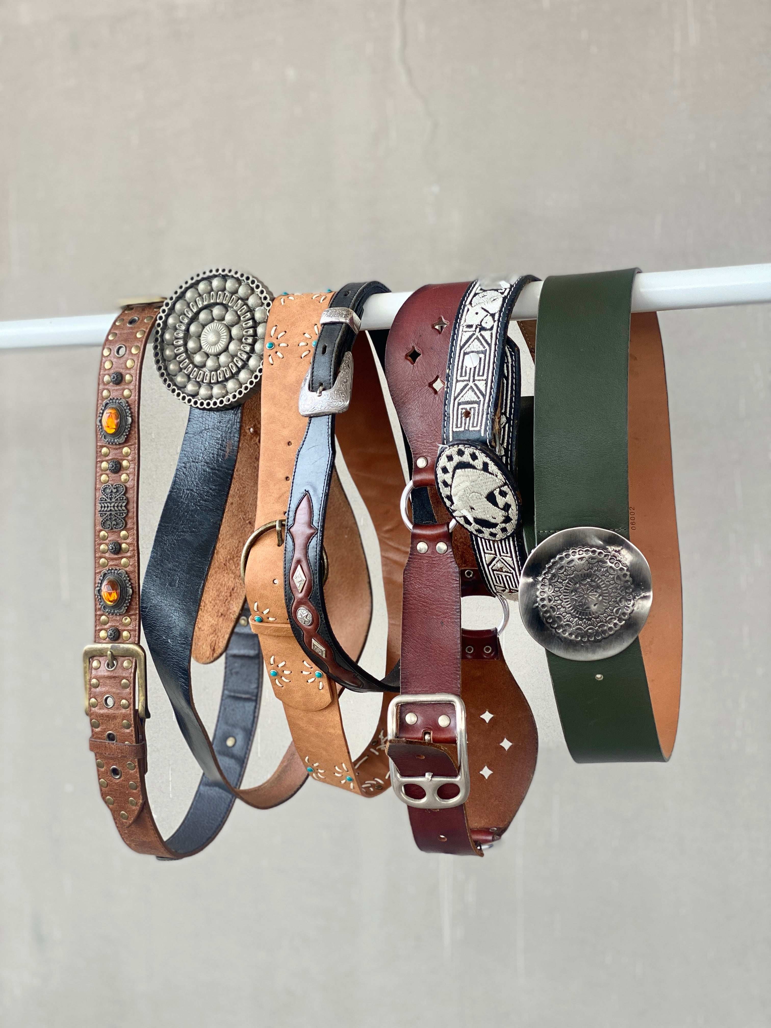Vintage leather belts with ornate buckles and studs, perfect for 90s Y2K retro style