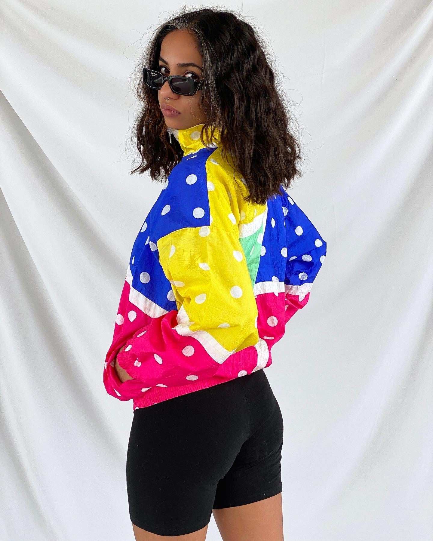 Colorful 90s polka dot windbreaker jacket, vintage Y2K style with bold blue, yellow, pink blocks