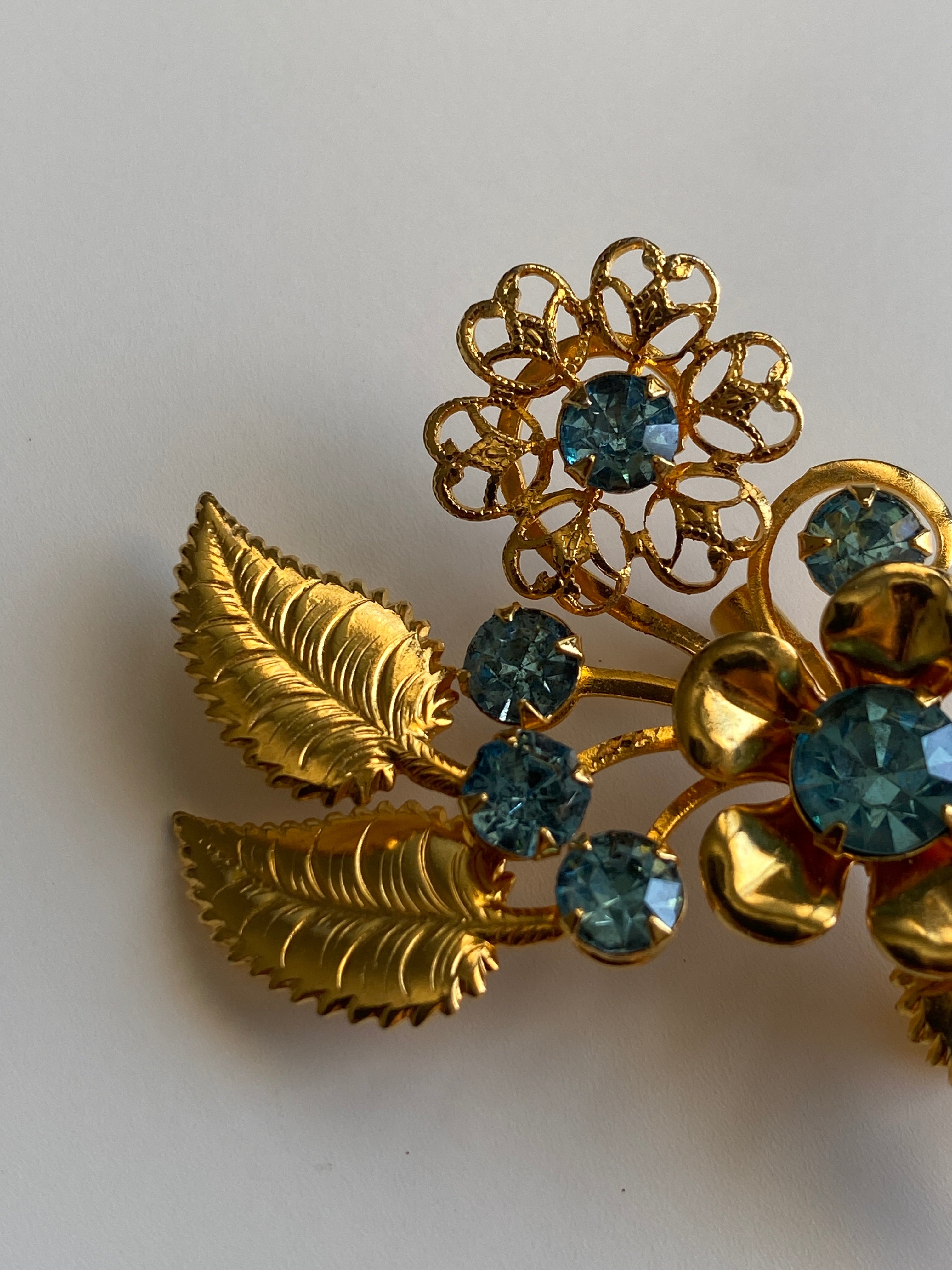 Vintage Gold Tone Blue Rhinestone Floral Spray Brooch with Cabochon Accent Pin
