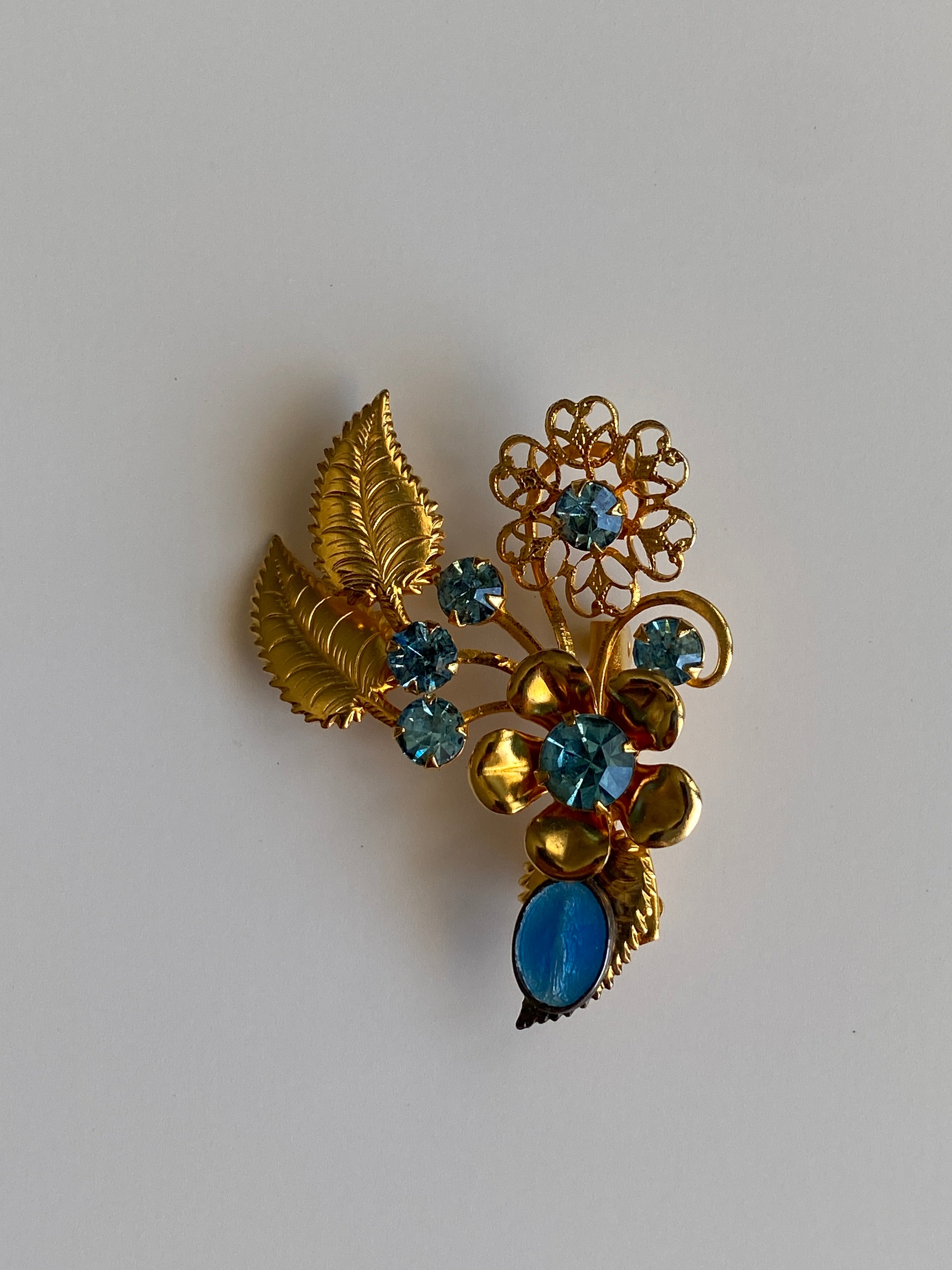 Vintage Gold Tone Blue Rhinestone Floral Spray Brooch with Cabochon Accent Pin