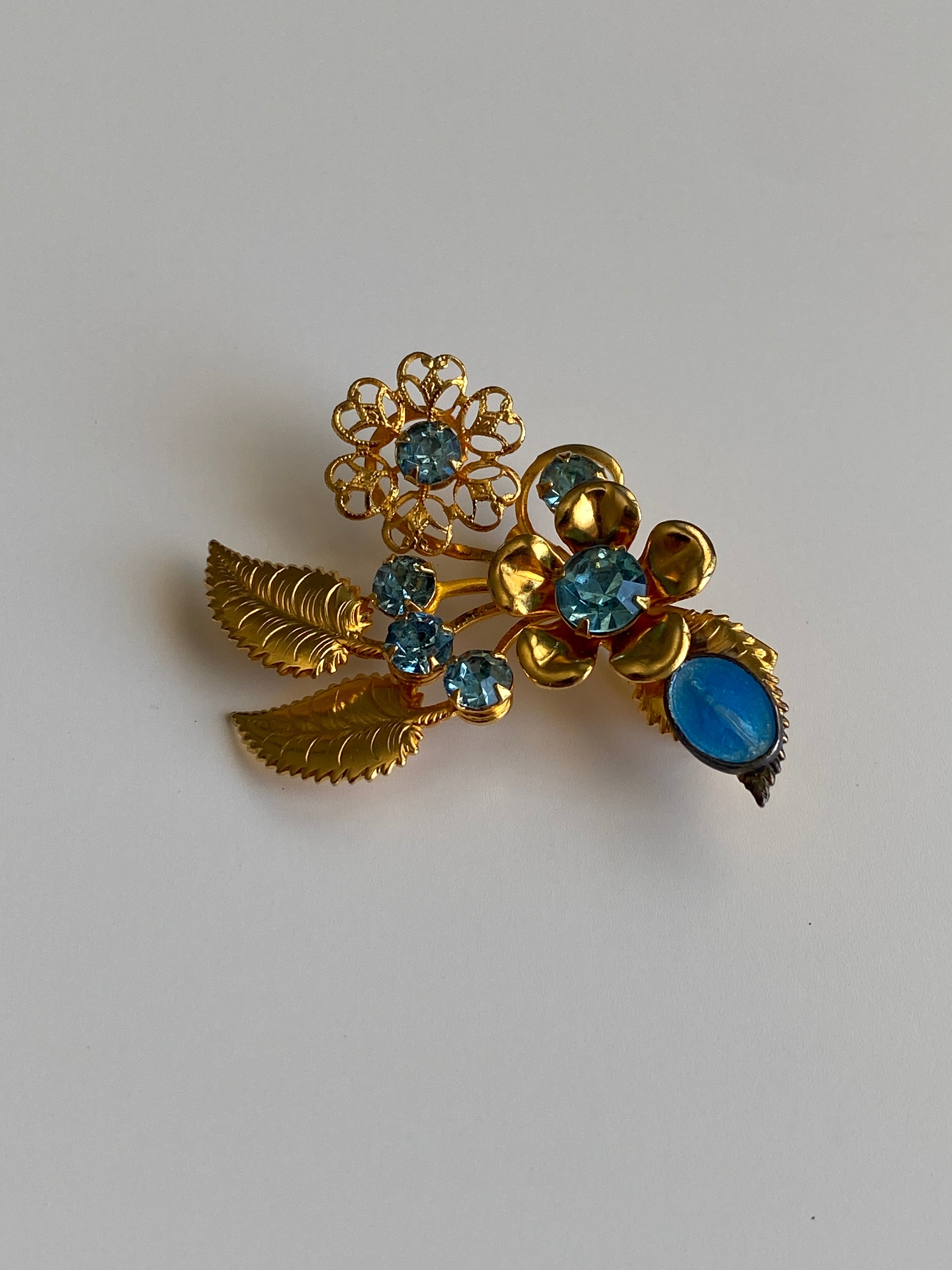 Vintage Gold Tone Blue Rhinestone Floral Spray Brooch with Cabochon Accent Pin