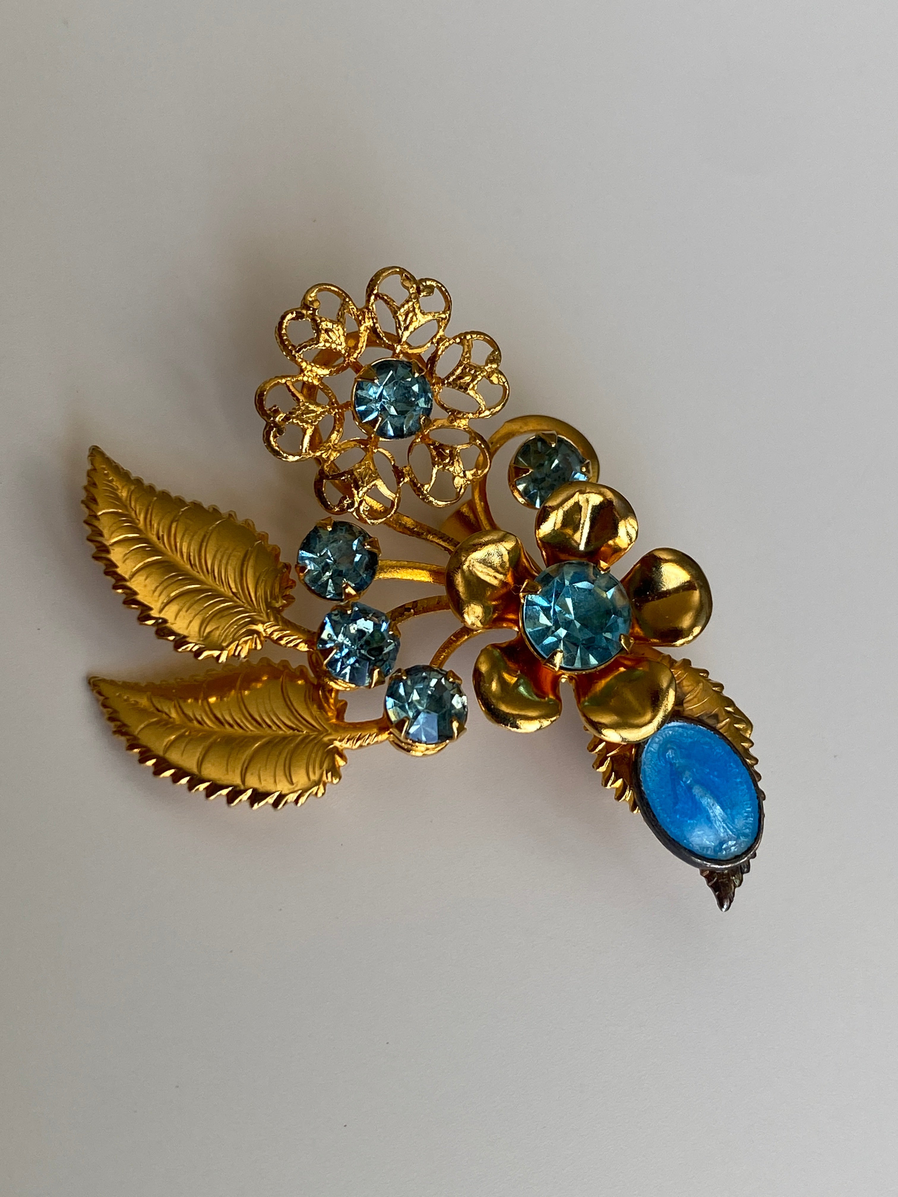 Vintage Gold Tone Blue Rhinestone Floral Spray Brooch with Cabochon Accent Pin