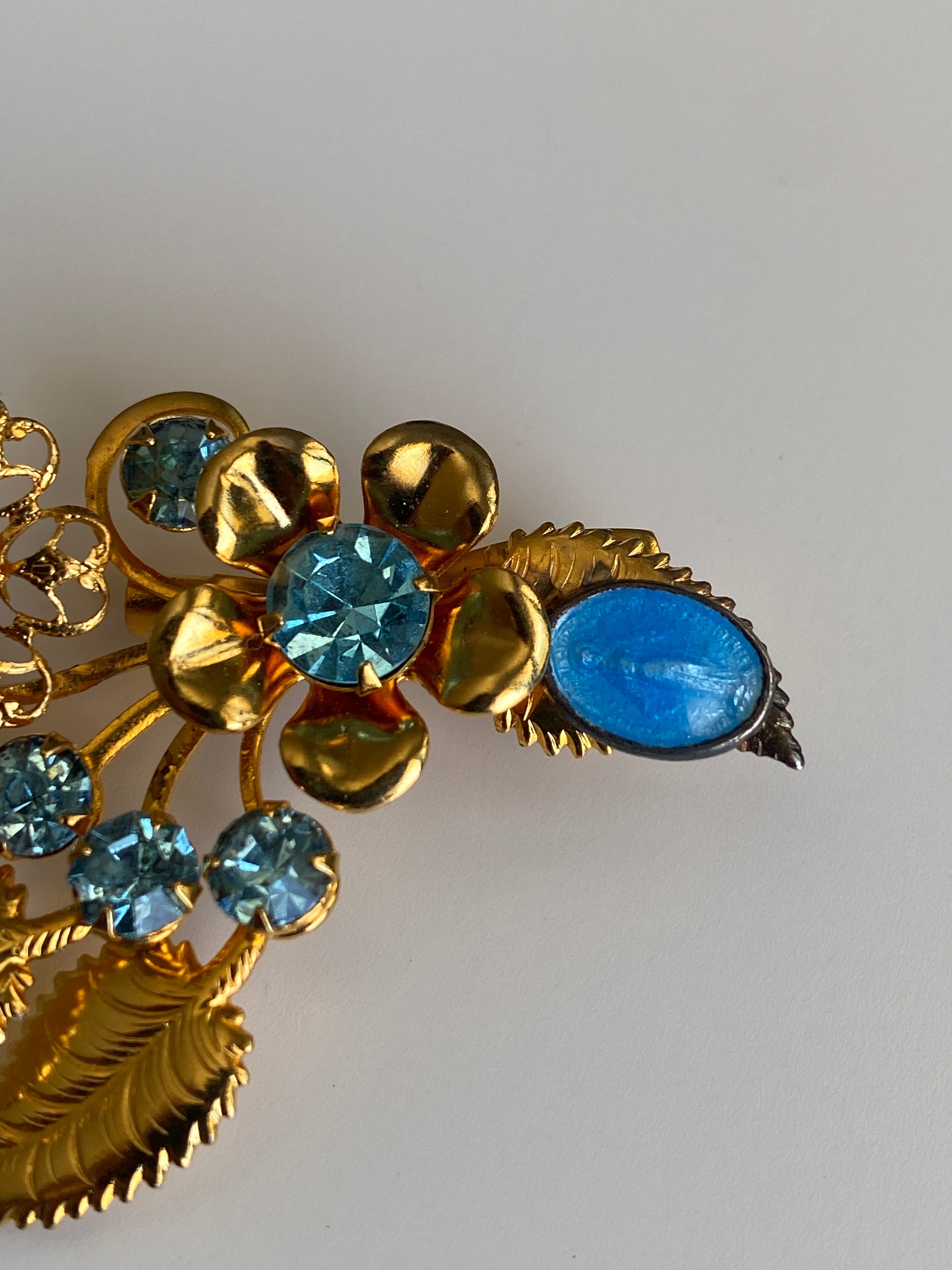 Vintage Gold Tone Blue Rhinestone Floral Spray Brooch with Cabochon Accent Pin